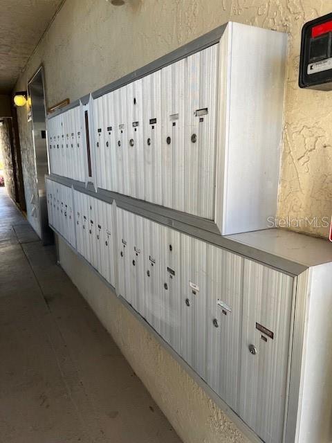 hallway featuring a mail area