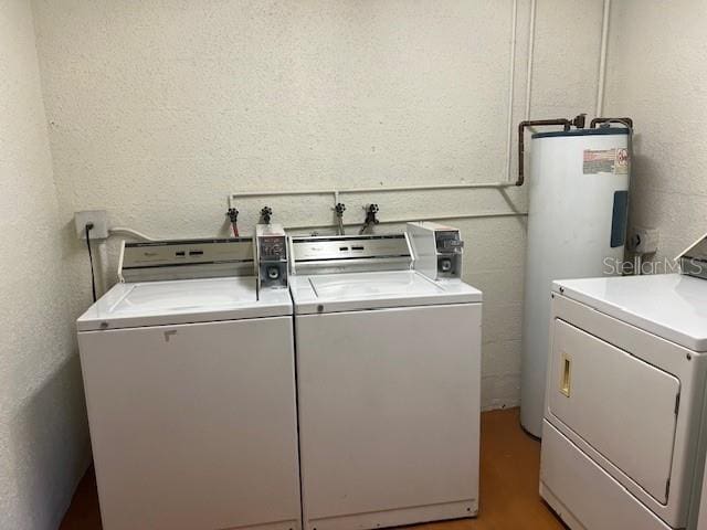 washroom with washer and dryer and water heater