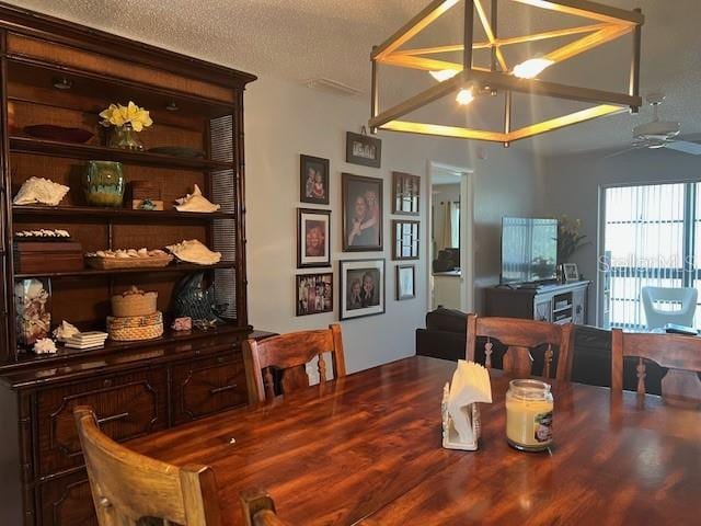 dining area featuring a textured ceiling and ceiling fan