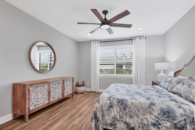 bedroom with ceiling fan and light wood-type flooring