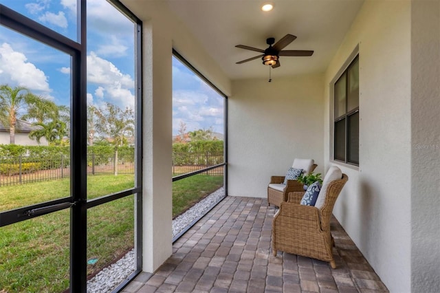 sunroom featuring ceiling fan