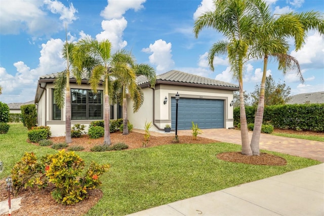 mediterranean / spanish-style home featuring a front lawn and a garage