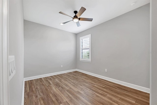 empty room with ceiling fan and light hardwood / wood-style flooring