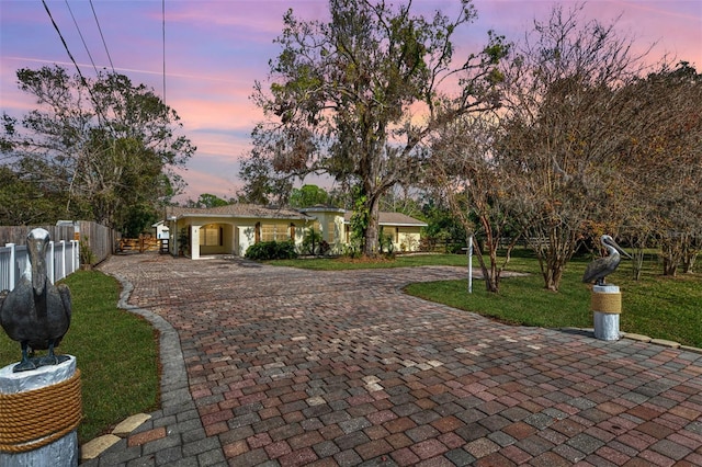 ranch-style home with a lawn