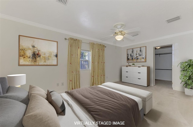 bedroom featuring light colored carpet, ornamental molding, ceiling fan, and a spacious closet