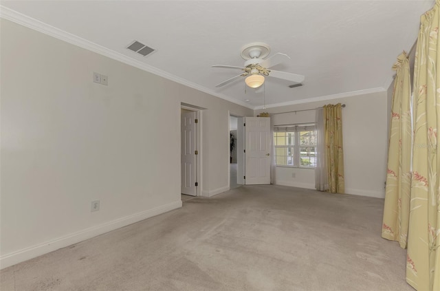 carpeted spare room featuring ornamental molding and ceiling fan