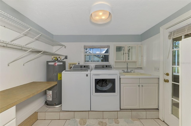 laundry room with sink, washing machine and dryer, cabinets, electric water heater, and light tile patterned flooring