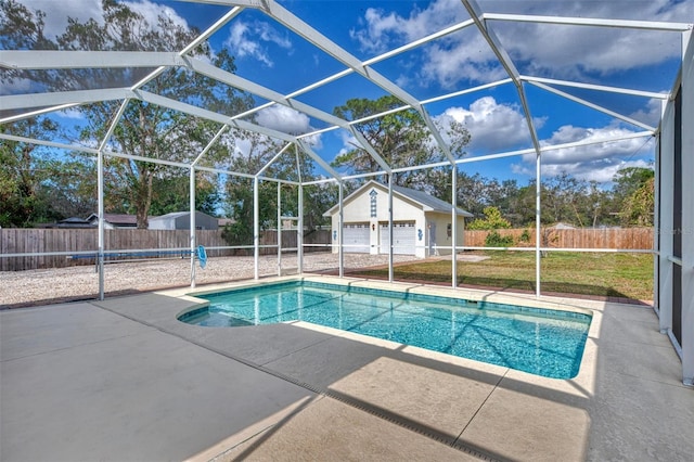 view of swimming pool with a garage, an outbuilding, a yard, a lanai, and a patio