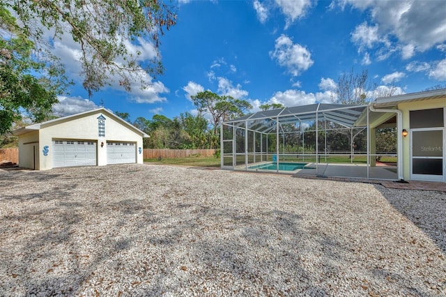 view of yard with a fenced in pool and glass enclosure