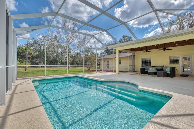 view of swimming pool featuring an outdoor living space, ceiling fan, glass enclosure, and a patio area