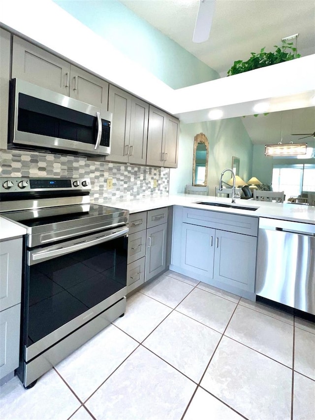 kitchen featuring gray cabinets, sink, and stainless steel appliances