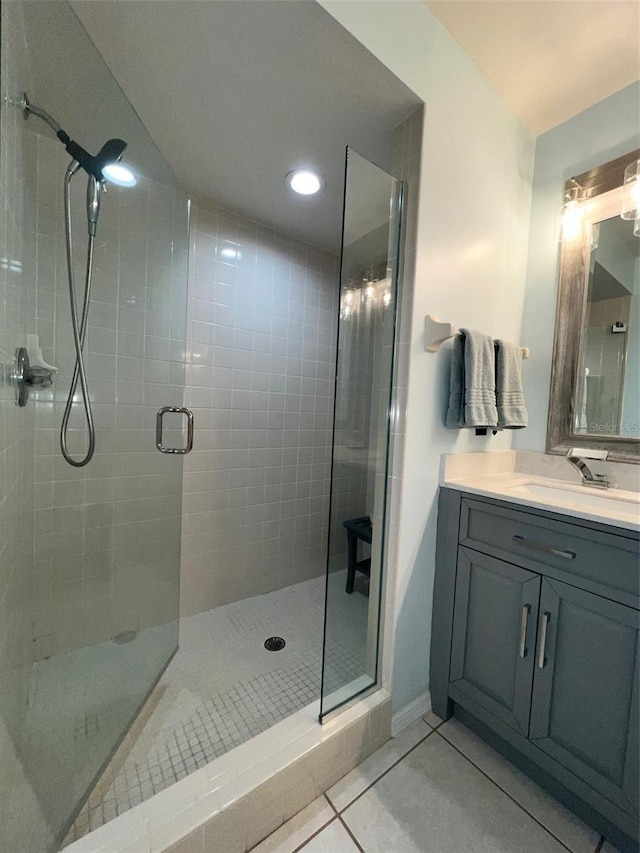 bathroom with tile patterned flooring, vanity, and an enclosed shower