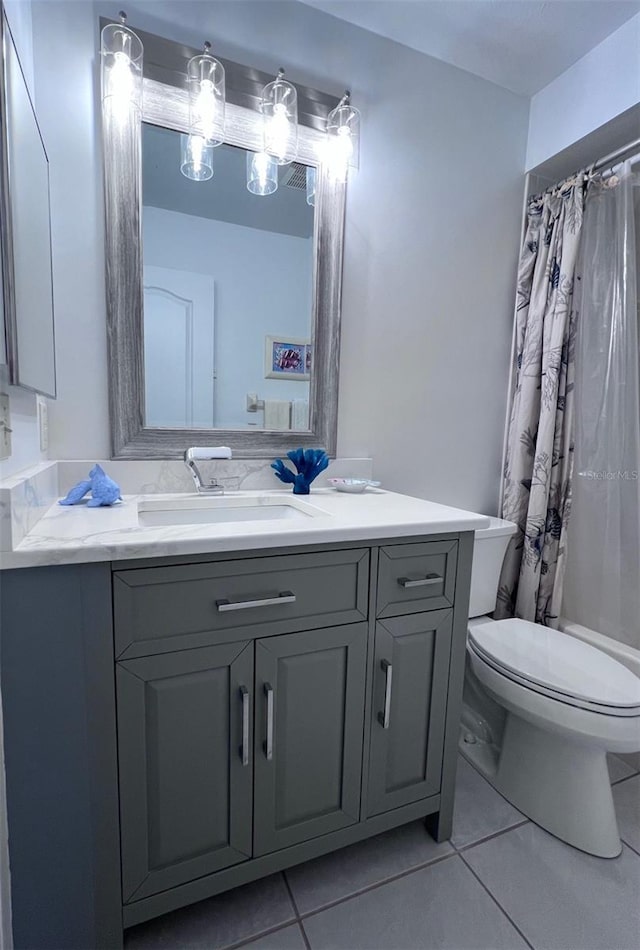 bathroom with tile patterned floors, vanity, toilet, and a shower with curtain