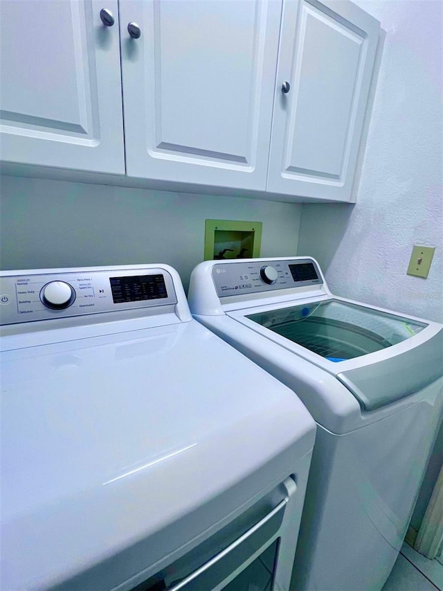 laundry area featuring cabinets and washing machine and clothes dryer