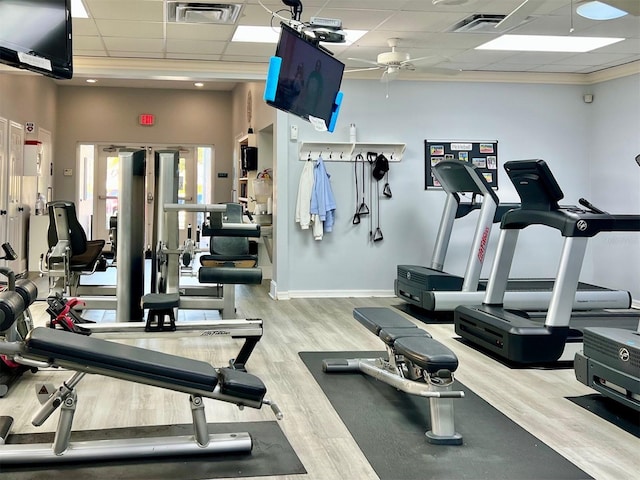 gym with a paneled ceiling, hardwood / wood-style flooring, and ceiling fan