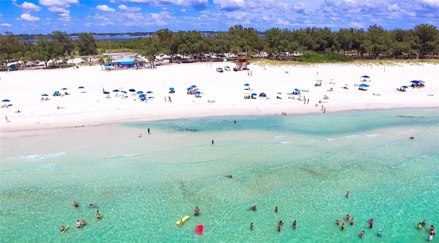 drone / aerial view featuring a water view and a beach view