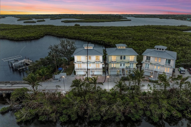 aerial view at dusk with a water view