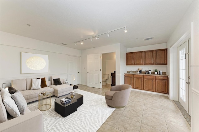 living room featuring light tile patterned floors and a textured ceiling