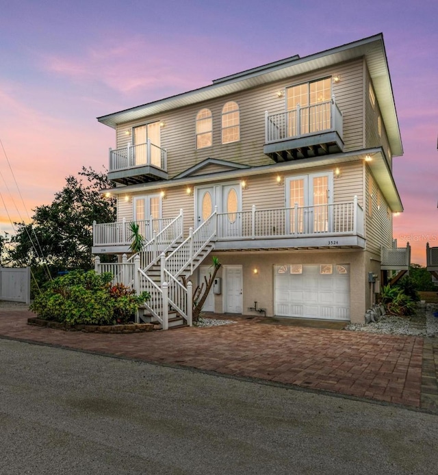 view of front of house with a garage and a balcony