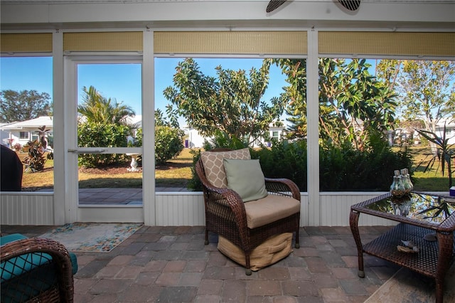 sunroom / solarium with plenty of natural light and ceiling fan