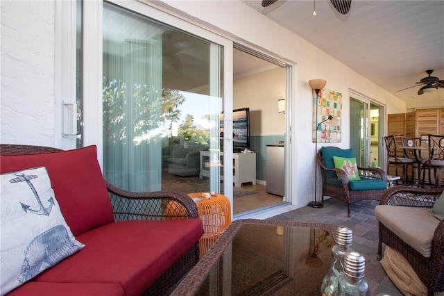 sunroom featuring ceiling fan