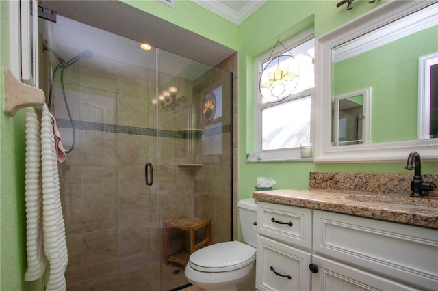 bathroom featuring toilet, vanity, an enclosed shower, and ornamental molding