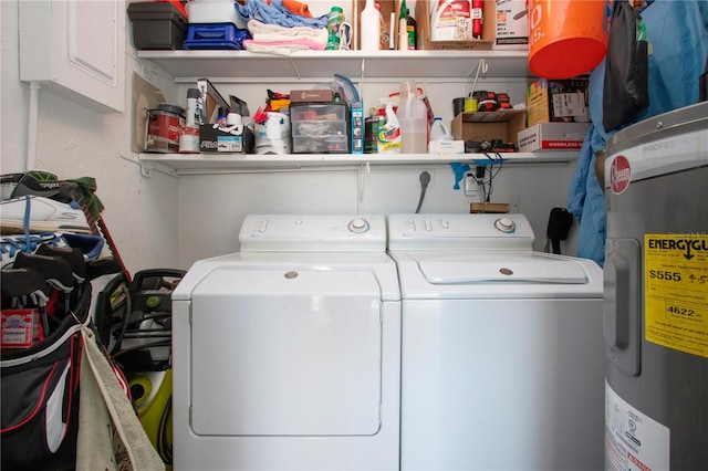 washroom with washing machine and dryer and water heater