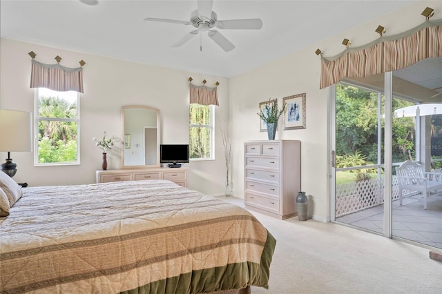 bedroom featuring multiple windows, light carpet, ceiling fan, and access to outside