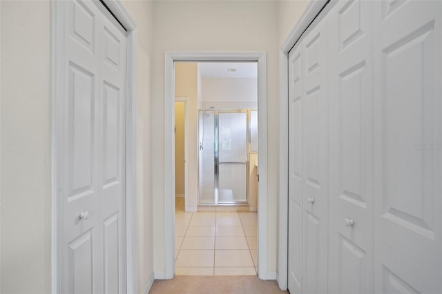 hall featuring light tile patterned floors