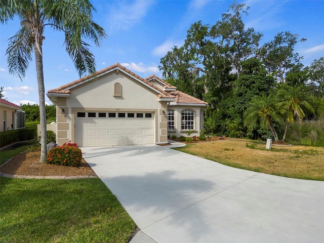 mediterranean / spanish-style home with a front lawn and a garage