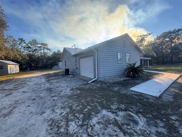 property exterior at dusk with a garage and central AC unit