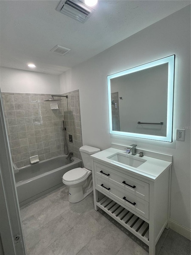 full bathroom featuring vanity, toilet, and tiled shower / bath