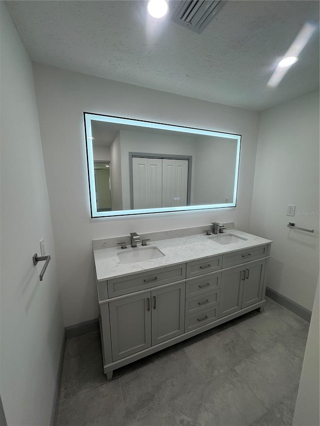 bathroom featuring vanity and a textured ceiling