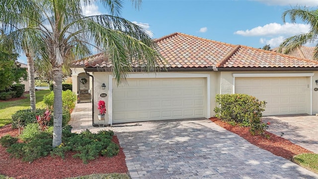 mediterranean / spanish-style house with a garage