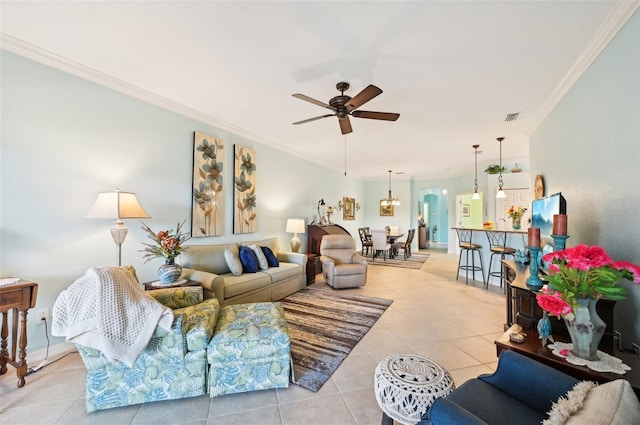 living room with ceiling fan, light tile patterned floors, and ornamental molding