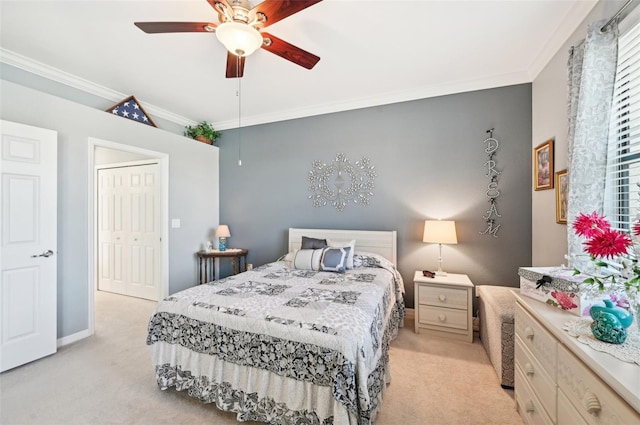 bedroom featuring ceiling fan, a closet, light colored carpet, and ornamental molding