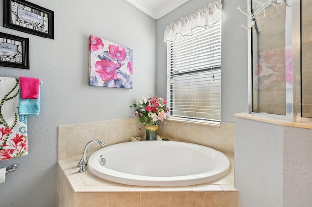 bathroom with tiled bath and ornamental molding