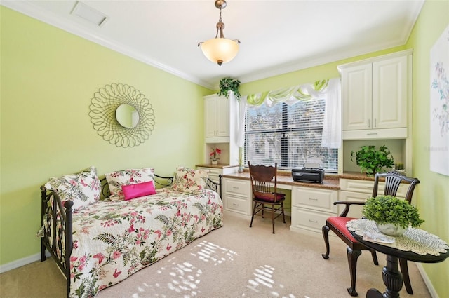 bedroom with light colored carpet, built in desk, and ornamental molding