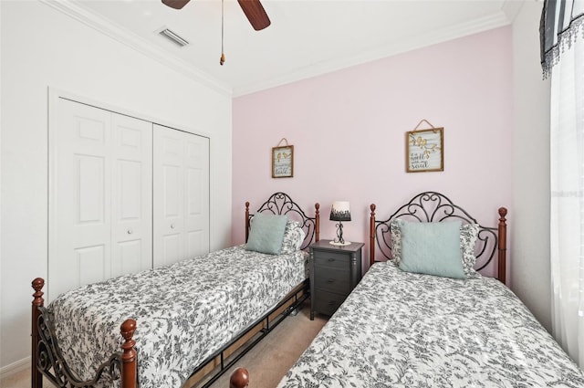 carpeted bedroom featuring ceiling fan, a closet, and ornamental molding