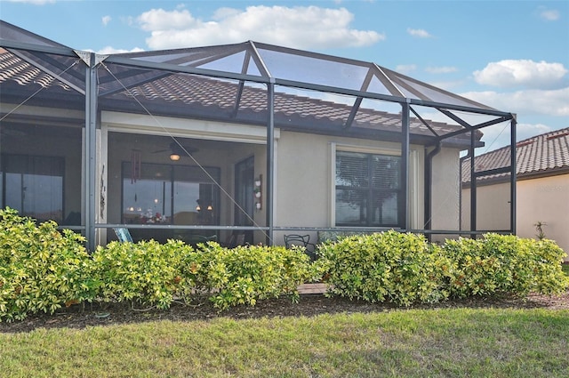 back of house featuring glass enclosure