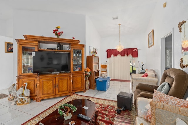 tiled living room featuring high vaulted ceiling and a notable chandelier