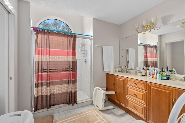 bathroom featuring vanity, an enclosed shower, and a textured ceiling