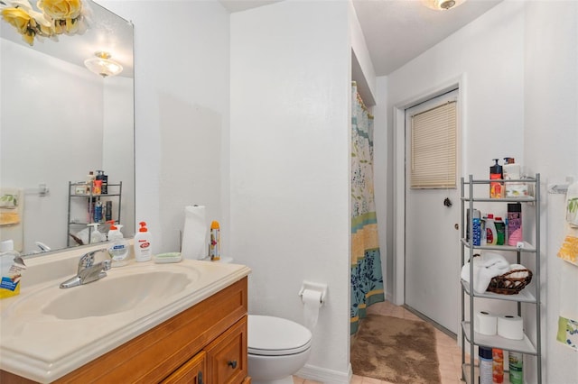 bathroom featuring tile patterned floors, vanity, a shower with shower curtain, and toilet