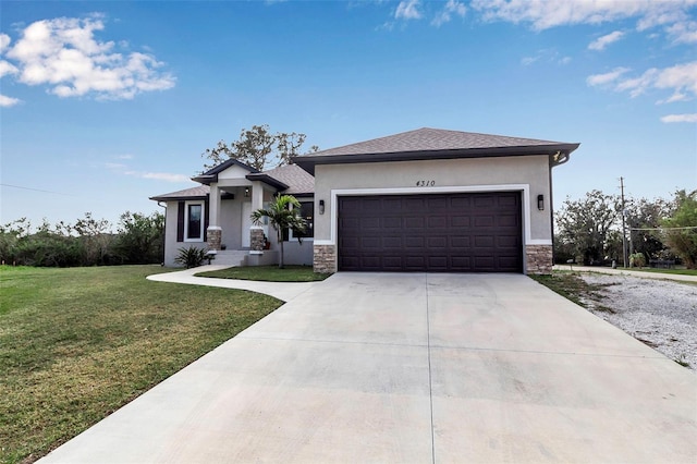 prairie-style house featuring a garage and a front yard