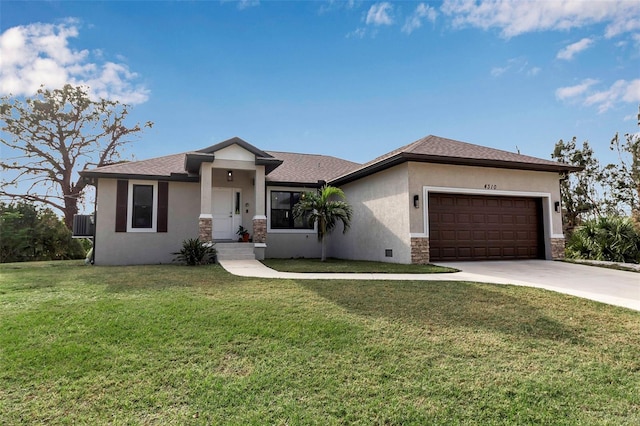 view of front of property with a front yard and a garage