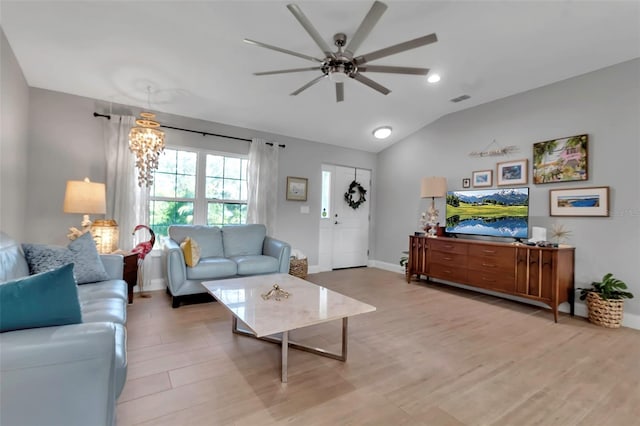 living room with light hardwood / wood-style flooring, ceiling fan with notable chandelier, and lofted ceiling