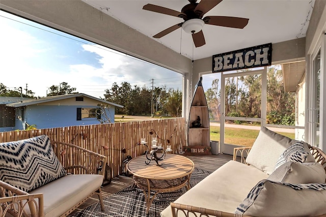 sunroom / solarium with ceiling fan and a healthy amount of sunlight