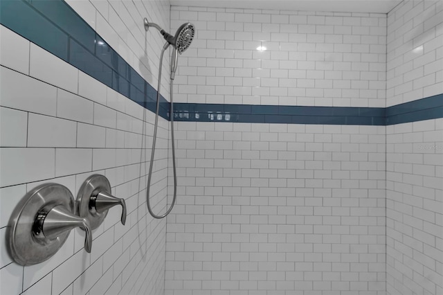 bathroom with tiled shower