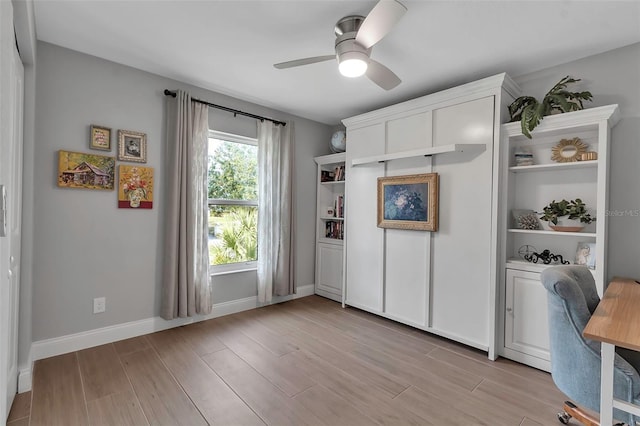 office with ceiling fan and light hardwood / wood-style flooring