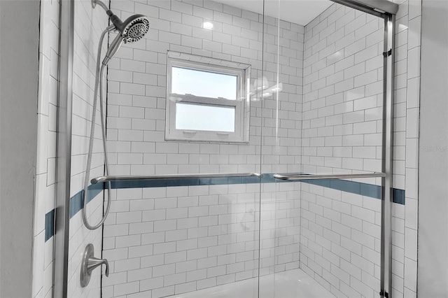 bathroom featuring shower / bath combination with glass door